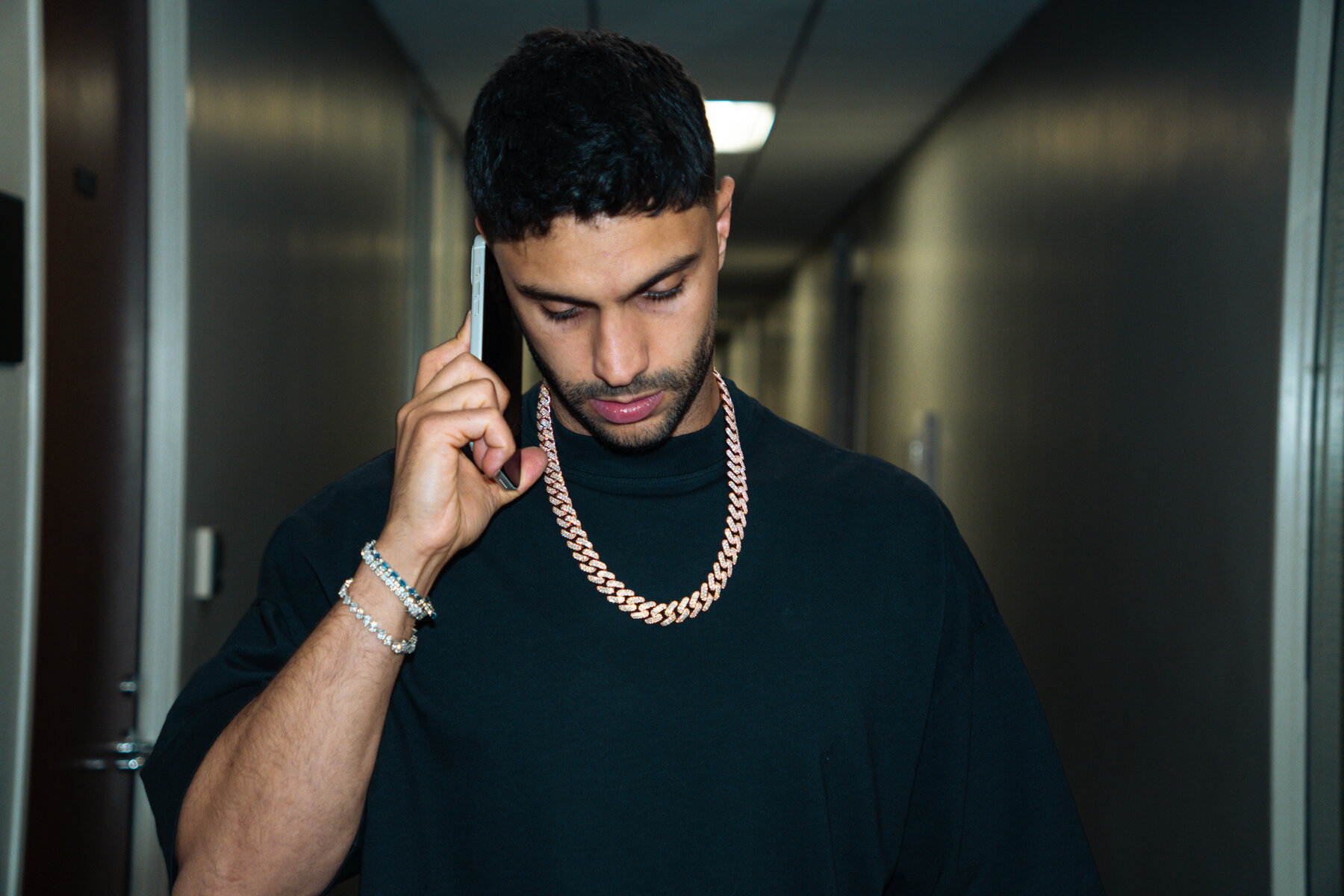 Dave on a call, rose gold cuban link chain
