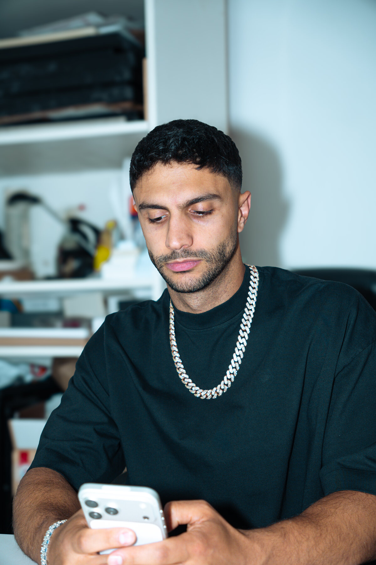 Diamond Dave in his office, cuban link chain, on the phone with a client